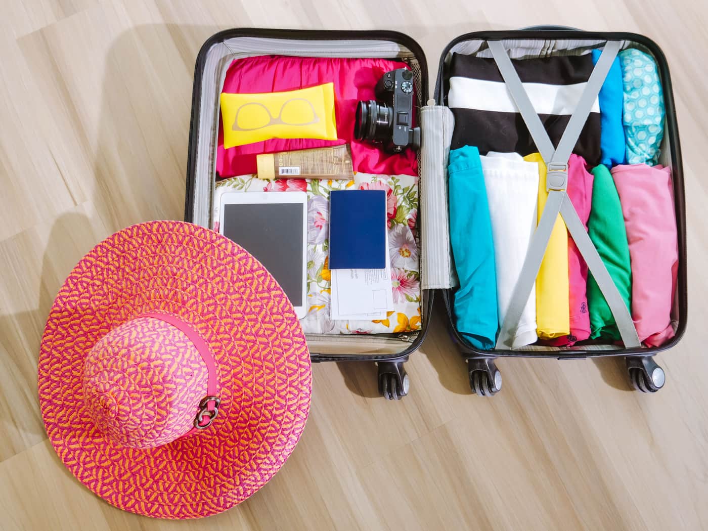 Travel clothing and accessories organized neatly inside a packed suitcase